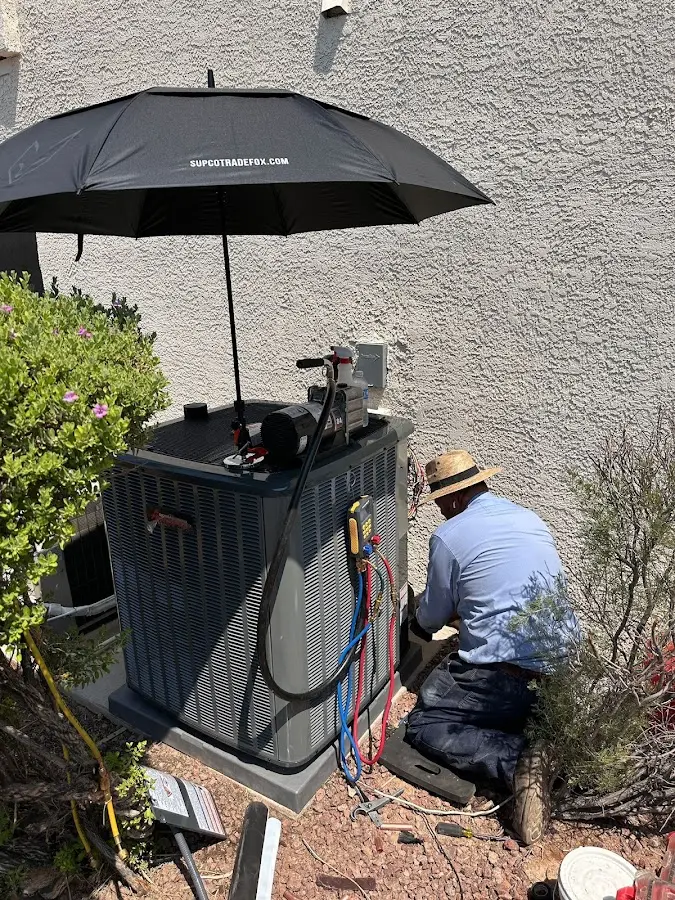 HVAC technician performing outdoor AC maintenance in Sarasota