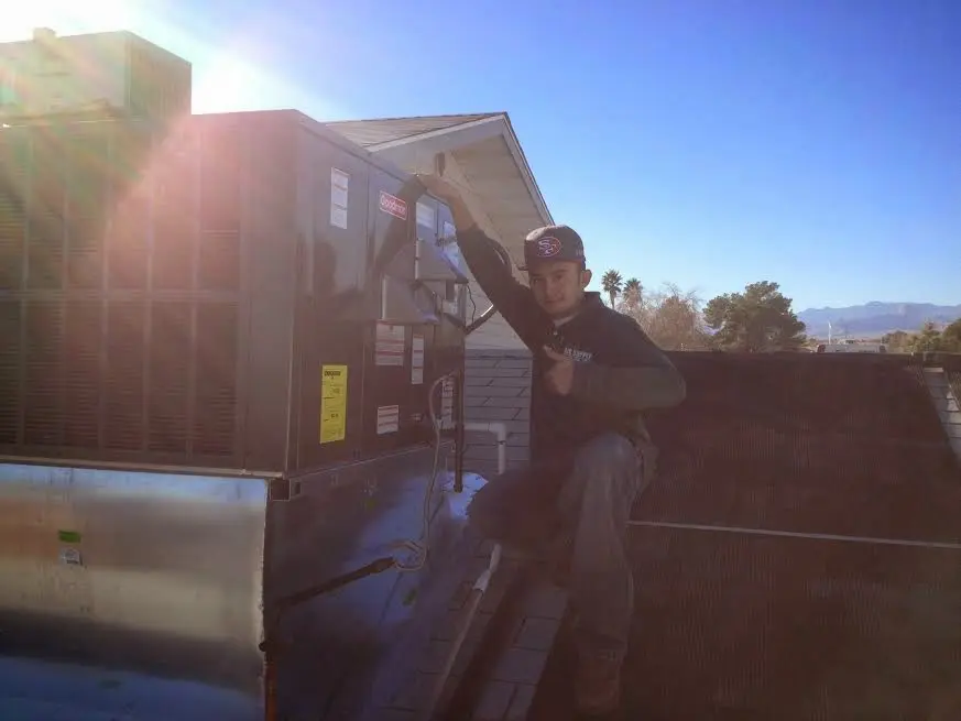 HVAC technician performing HVAC Inspection on a rooftop unit in Sarasota